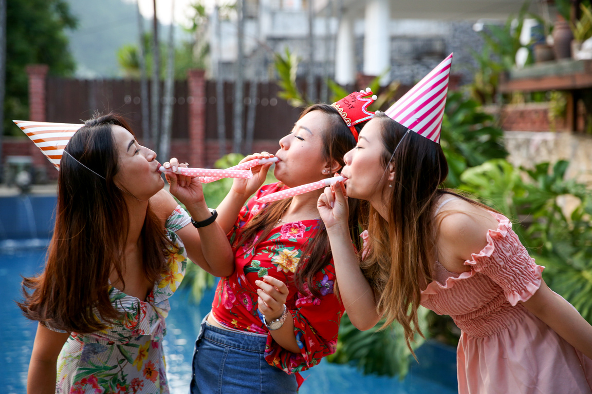 Friends celebrating birthday party at pool